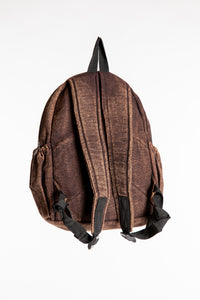 Back view of brown patchwork cotton backpack showing shoulder straps