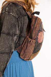 Side view of brown patchwork cotton backpack showing shoulder straps