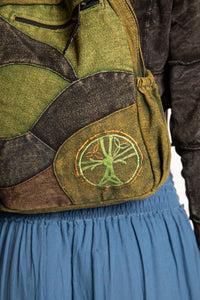 Close-up of the green ridgeline patchwork mini  backpack with green, dark brown, and black woven panels