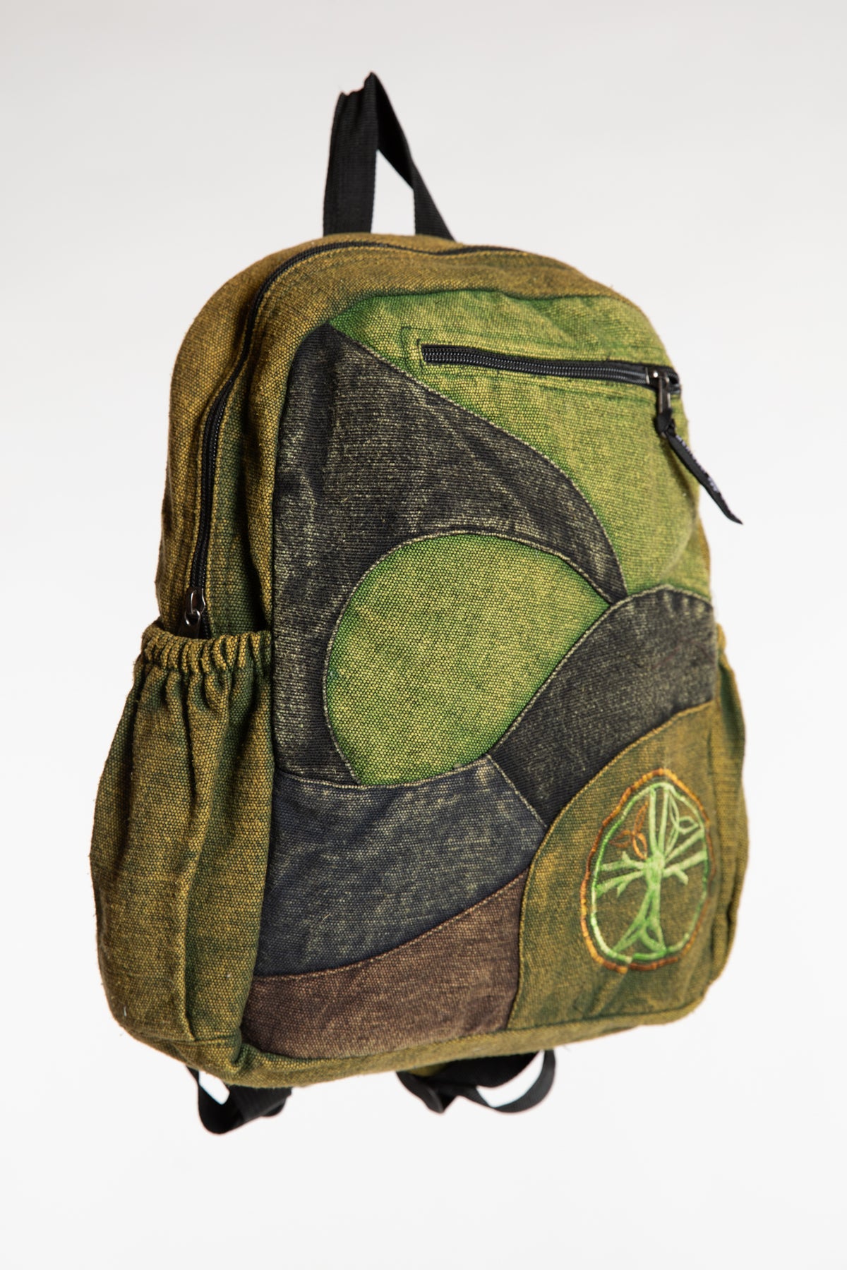 Green patchwork cotton backpack with earthy patterned panels and front pockets
