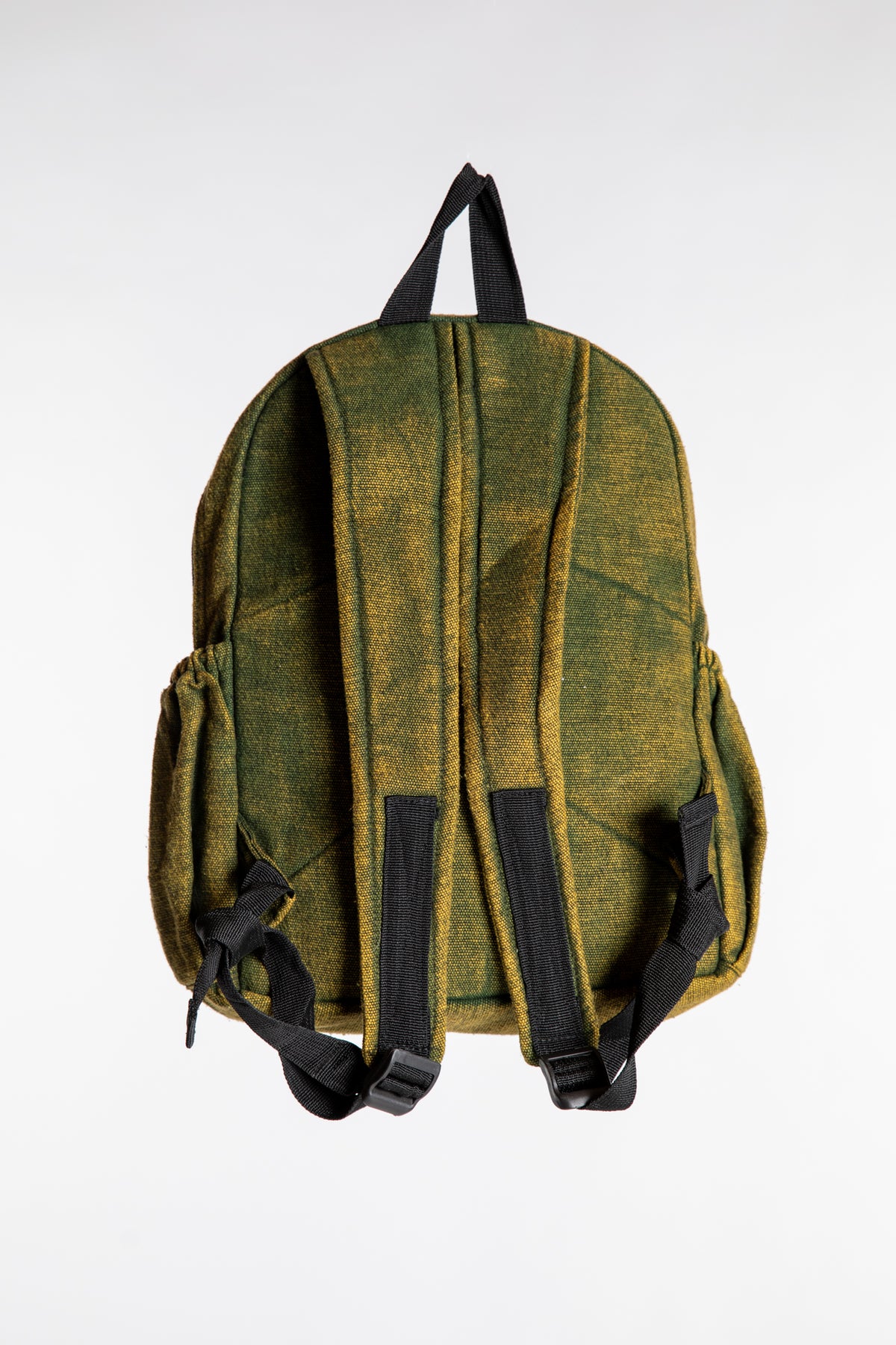 Back view of green patchwork cotton backpack showing shoulder straps