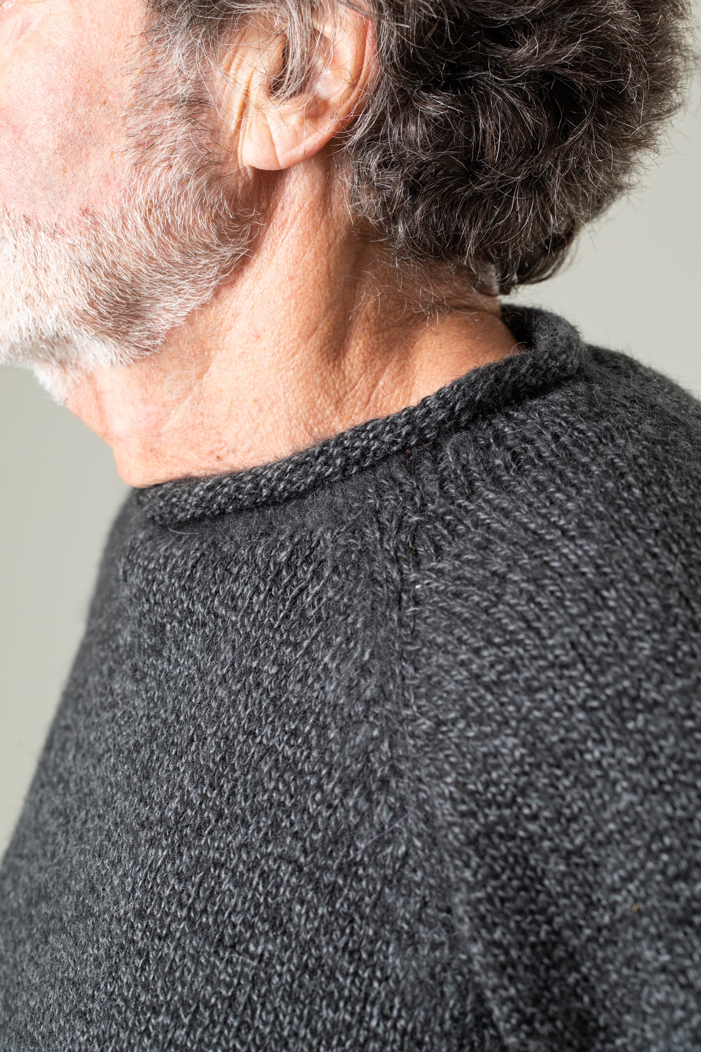 Bernie is wearing size L roll neck alpaca sweater in charcoal