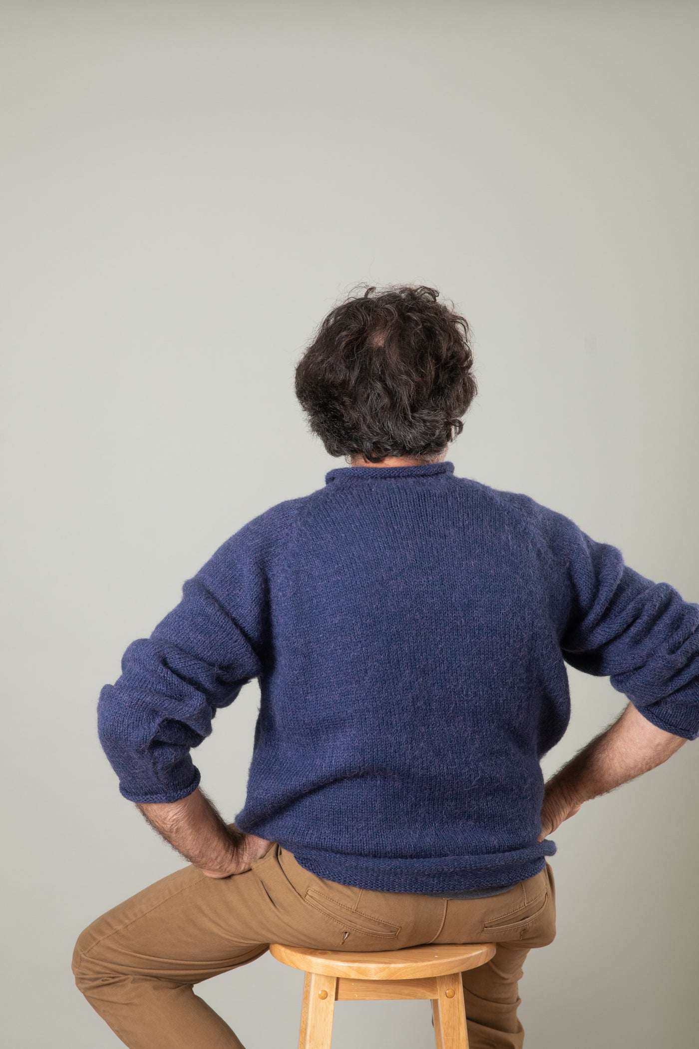 Bernie is wearing size L roll neck alpaca sweater in denim