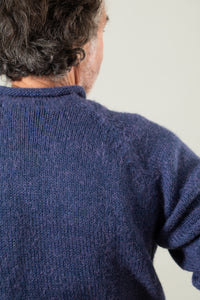 Bernie is wearing size L roll neck alpaca sweater in denim