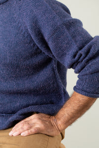 Bernie is wearing size L roll neck alpaca sweater in denim