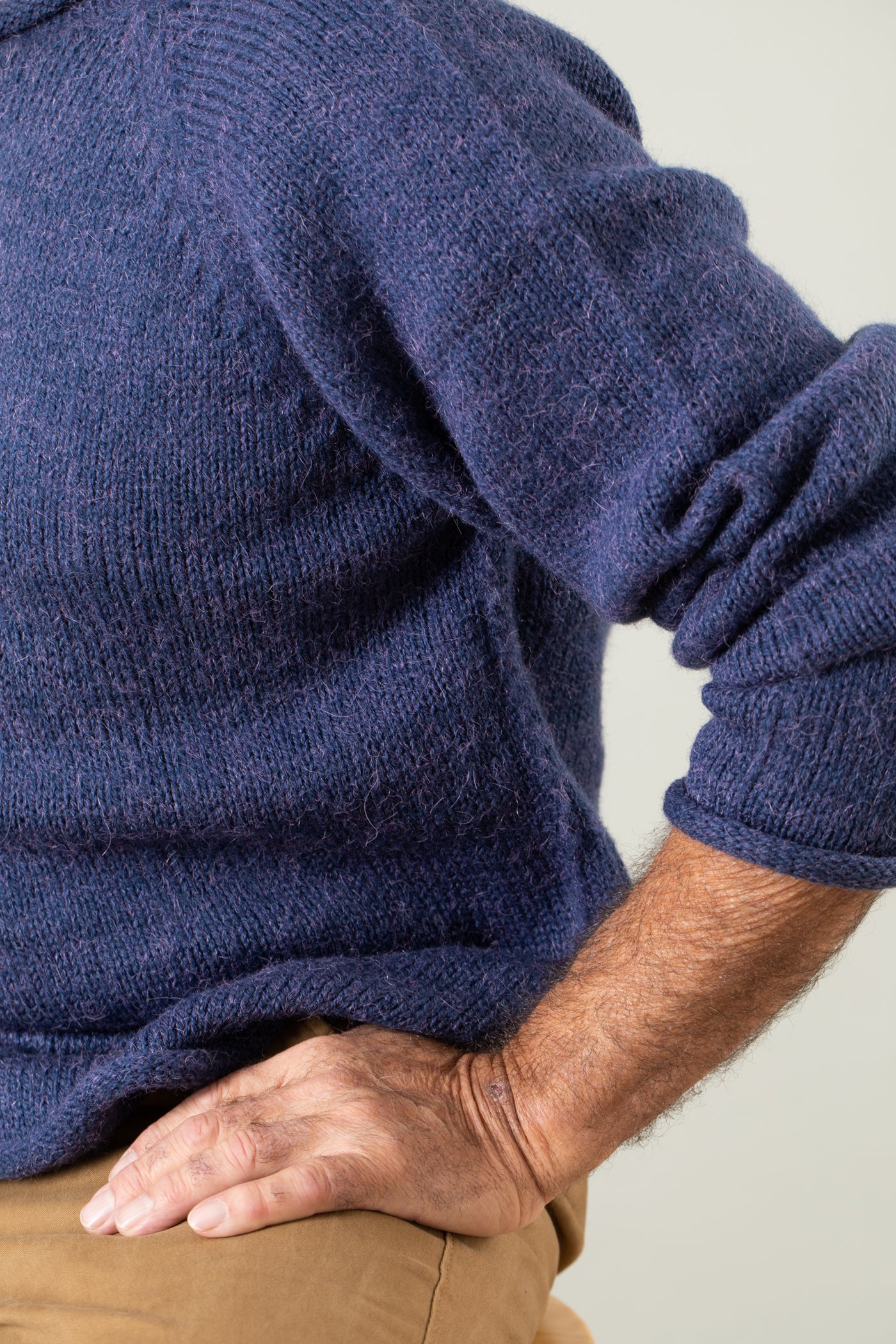 Bernie is wearing size L roll neck alpaca sweater in denim