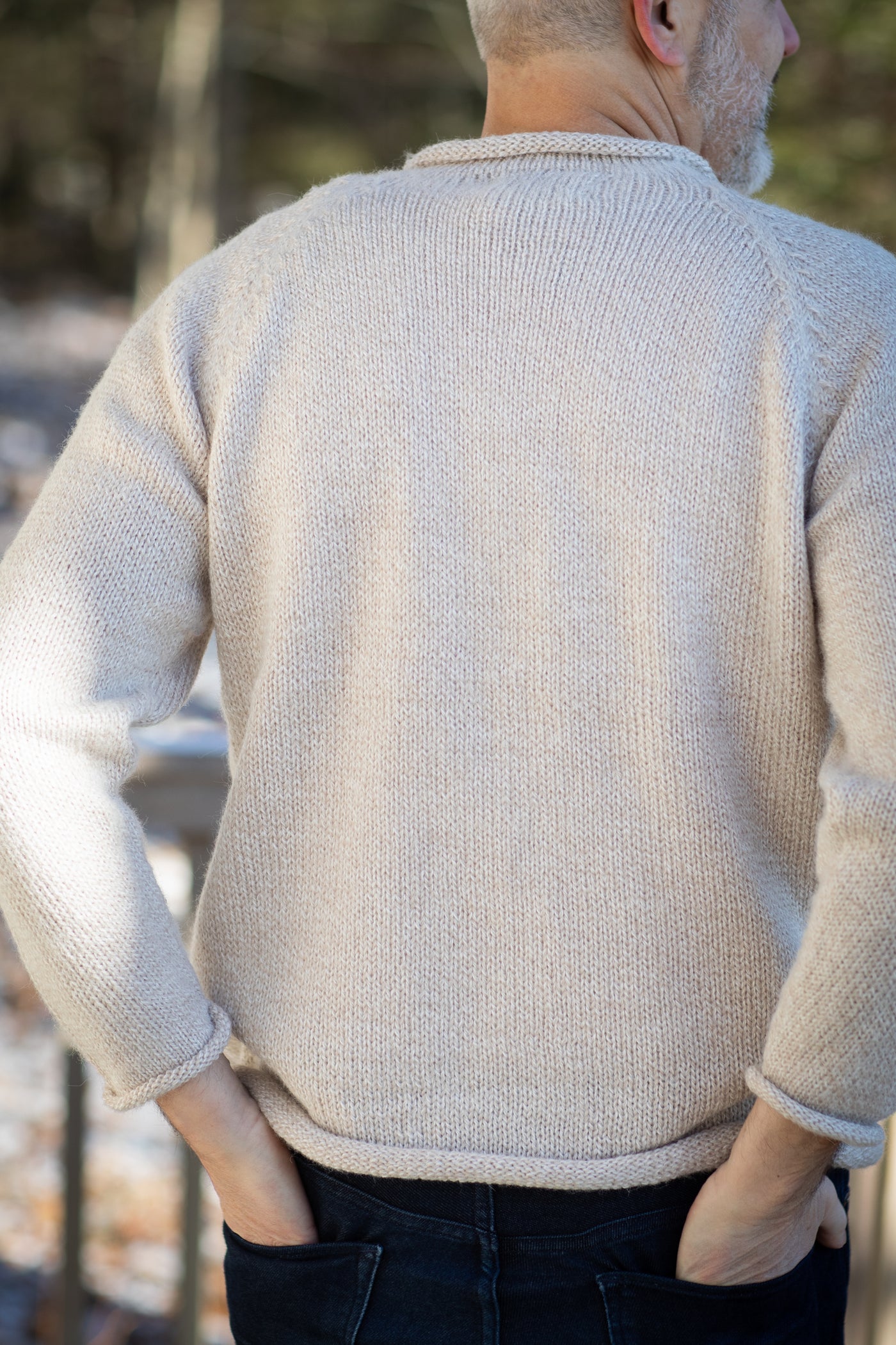 Michael is wearing size L roll neck alpaca sweater in oatmeal