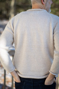 Michael is wearing size L roll neck alpaca sweater in oatmeal