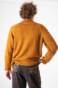 Ryan is wearing size XL roll neck alpaca sweater in sunflower