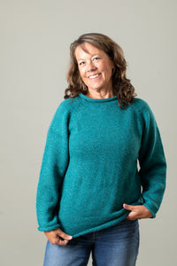 Jane wearing size Medium teal fisherman sweater against a plain background