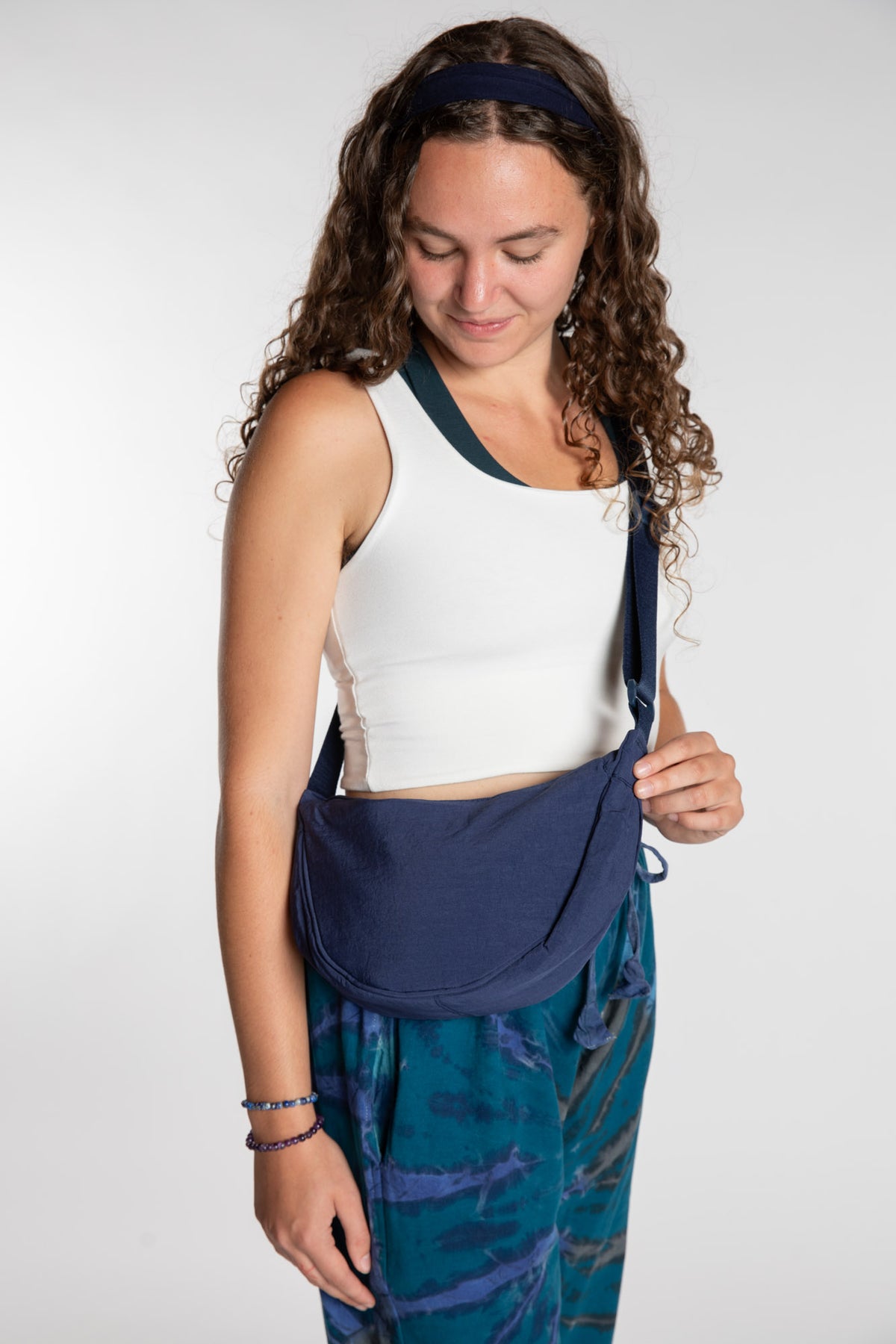 Emily is wearing the Samui Shoulder Bag in Navy