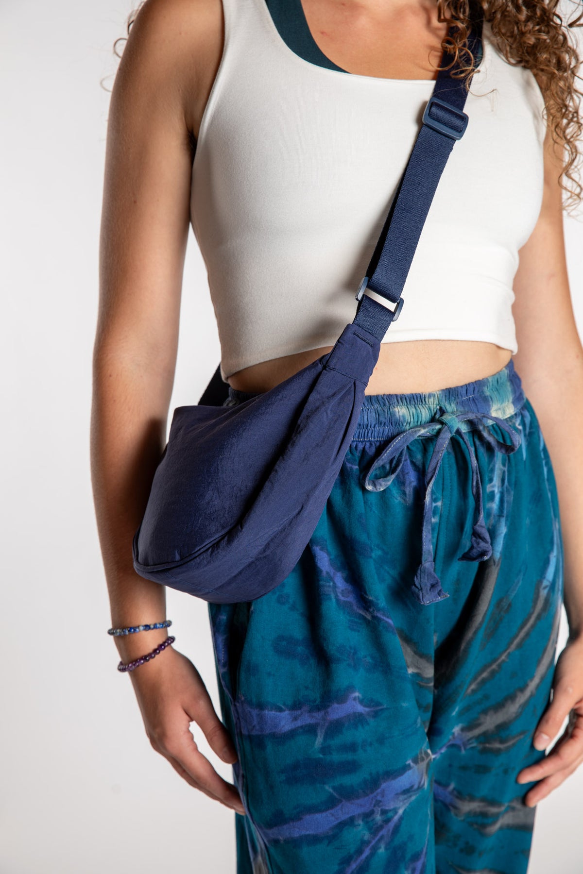 Emily is wearing the Samui Shoulder Bag in Navy