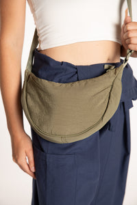 Emily is wearing the Samui Shoulder Bag in Olive