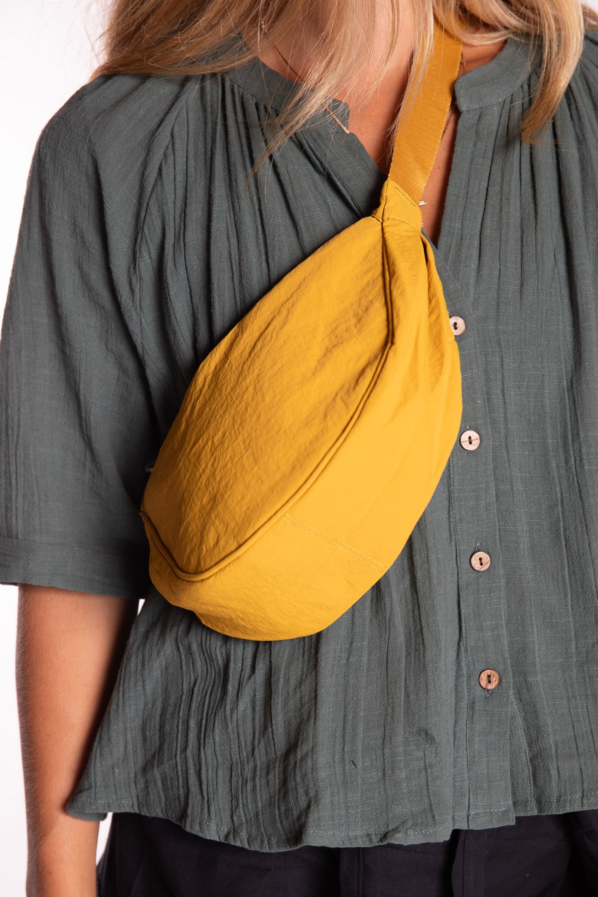 Sophie is wearing the Samui Shoulder Bag in Yellow 