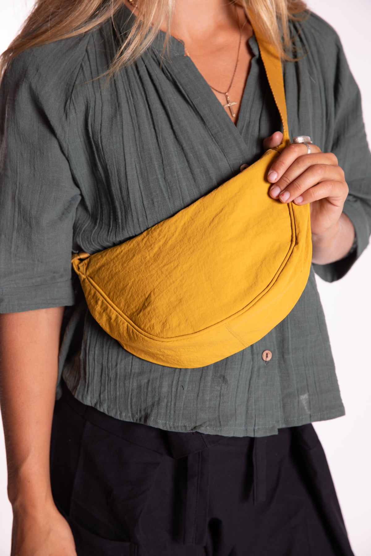 Sophie is wearing the Samui Shoulder Bag in Yellow 