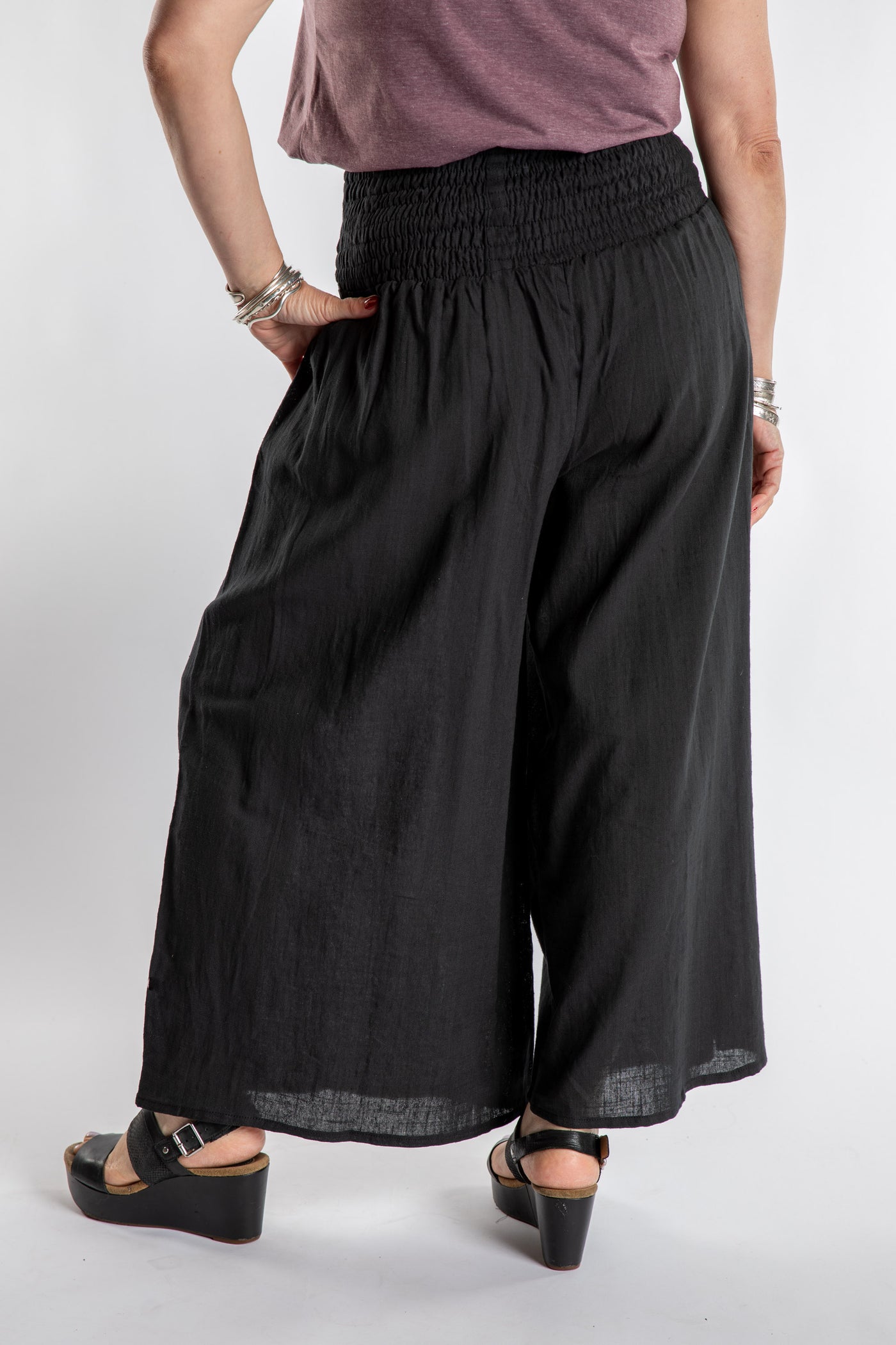 Susan is wearing the Saramati Palazzo Pants  in Black in L/XL