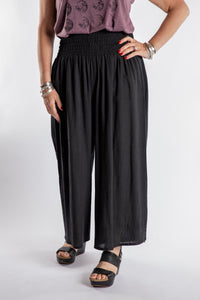 Susan is wearing the Saramati Palazzo Pants  in Black in L/XL