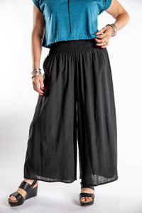 Susan is wearing the Saramati Palazzo Pants  in Black in L/XL
