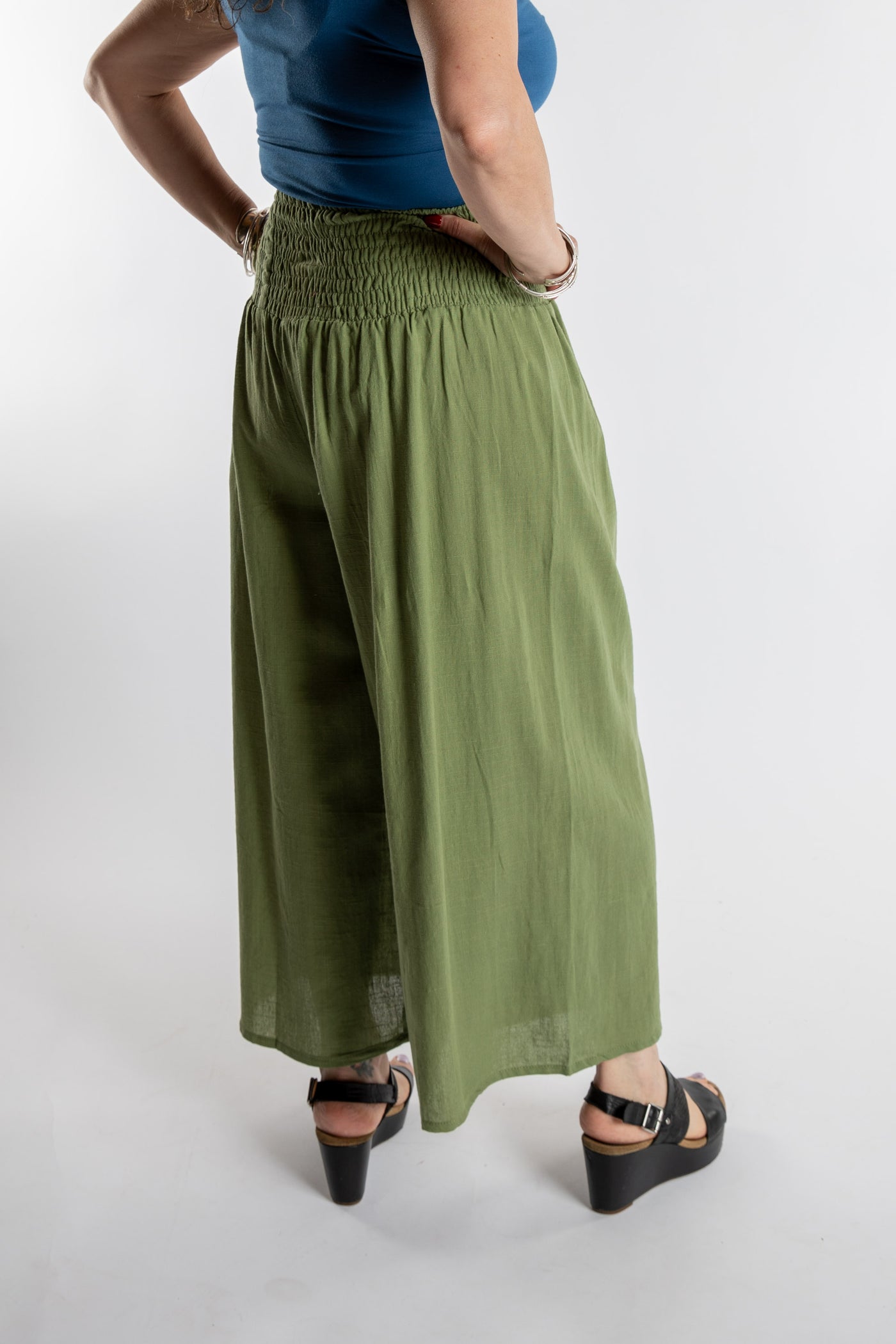 Susan is wearing the Saramati Palazzo Pants  in Green in L/XL