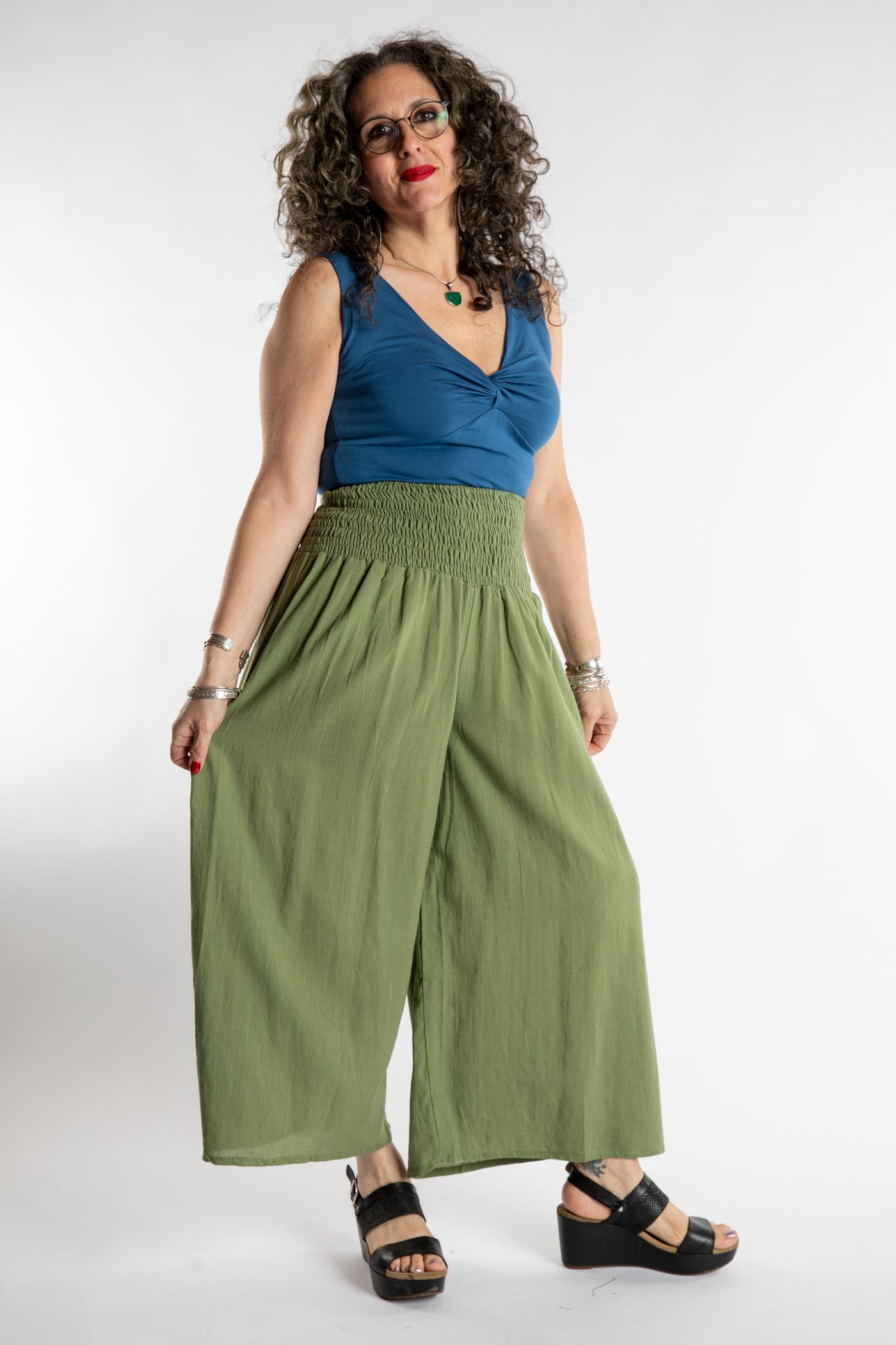 Susan is wearing the Saramati Palazzo Pants  in Green in L/XL