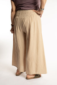 Betty is wearing the Saramati Palazzo Pants  in Tan in L/XL