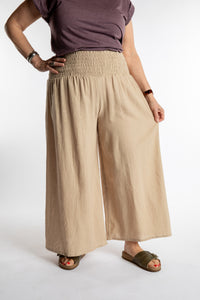 Betty is wearing the Saramati Palazzo Pants  in Tan in L/XL