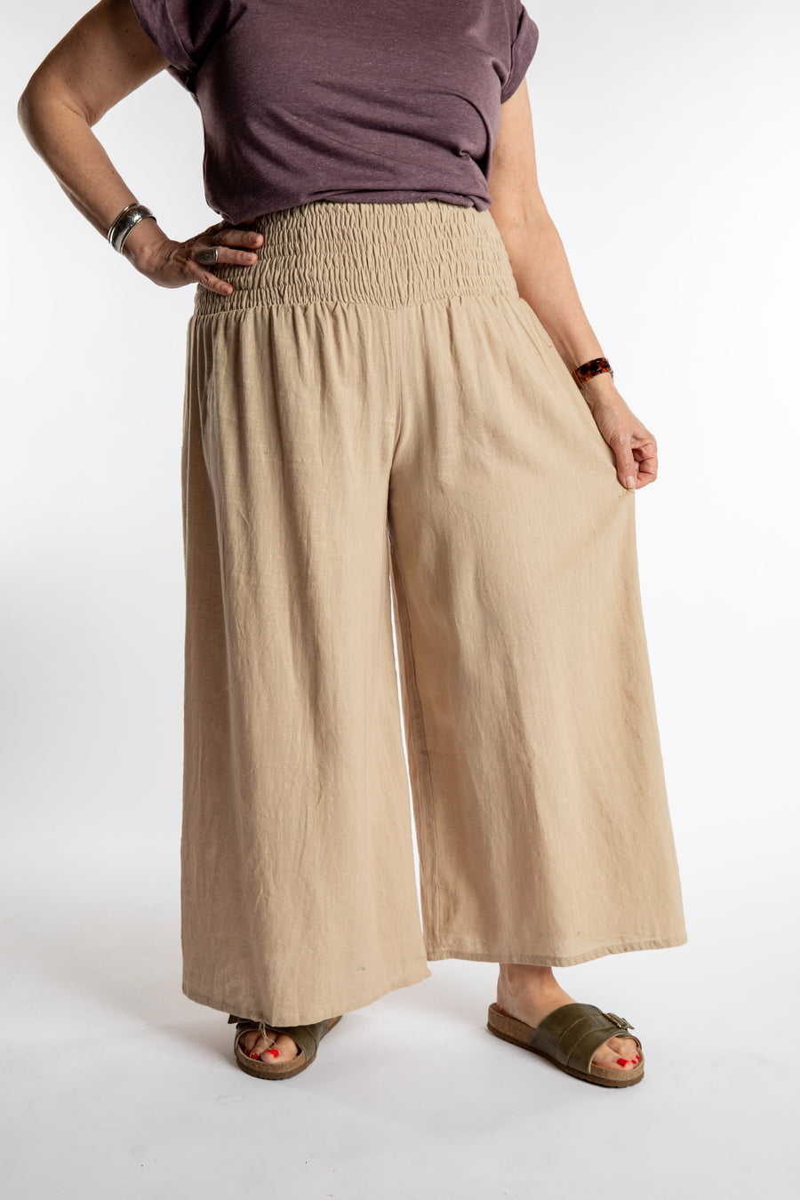 Betty is wearing the Saramati Palazzo Pants  in Tan in L/XL
