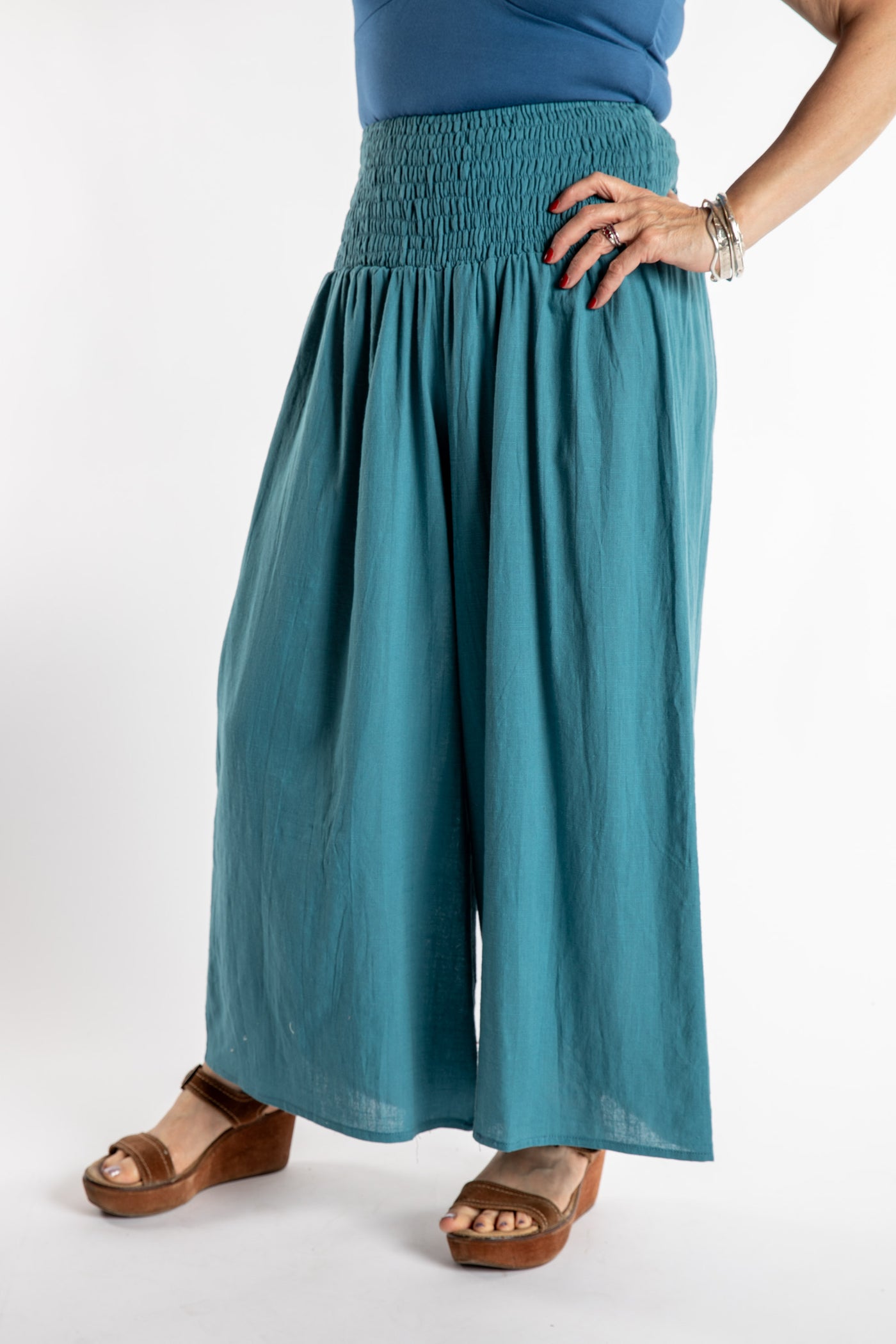 Susan is wearing the Saramati Palazzo Pants  in Teal in L/XL