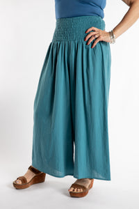 Susan is wearing the Saramati Palazzo Pants  in Teal in L/XL