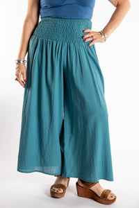 Susan is wearing the Saramati Palazzo Pants  in Teal in L/XL