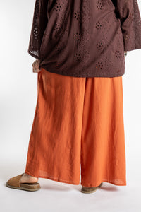 Betty is wearing the Saramati Palazzo Pants  in Terracotta in L/XL