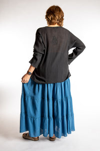 Betty is wearing the Saramati Prairie Skirt in one size in Blue
