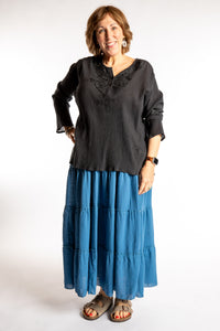 Betty is wearing the Saramati Prairie Skirt in one size in Blue