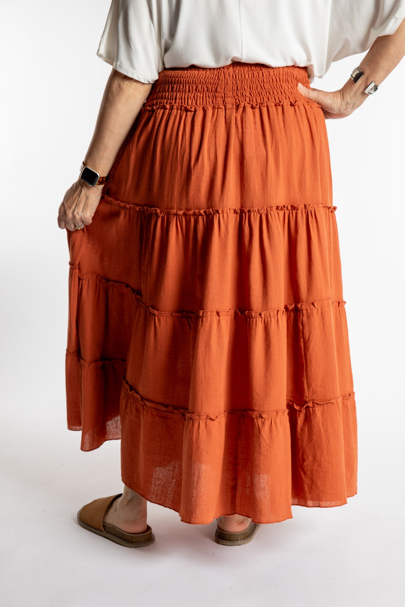 Betty is wearing the Saramati Prairie Skirt in one size in Terracotta
