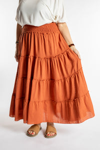 Betty is wearing the Saramati Prairie Skirt in one size in Terracotta