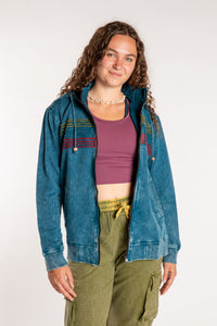 Emily is wearing the Blue Sathi Stripe ZIp Hoodie in Small