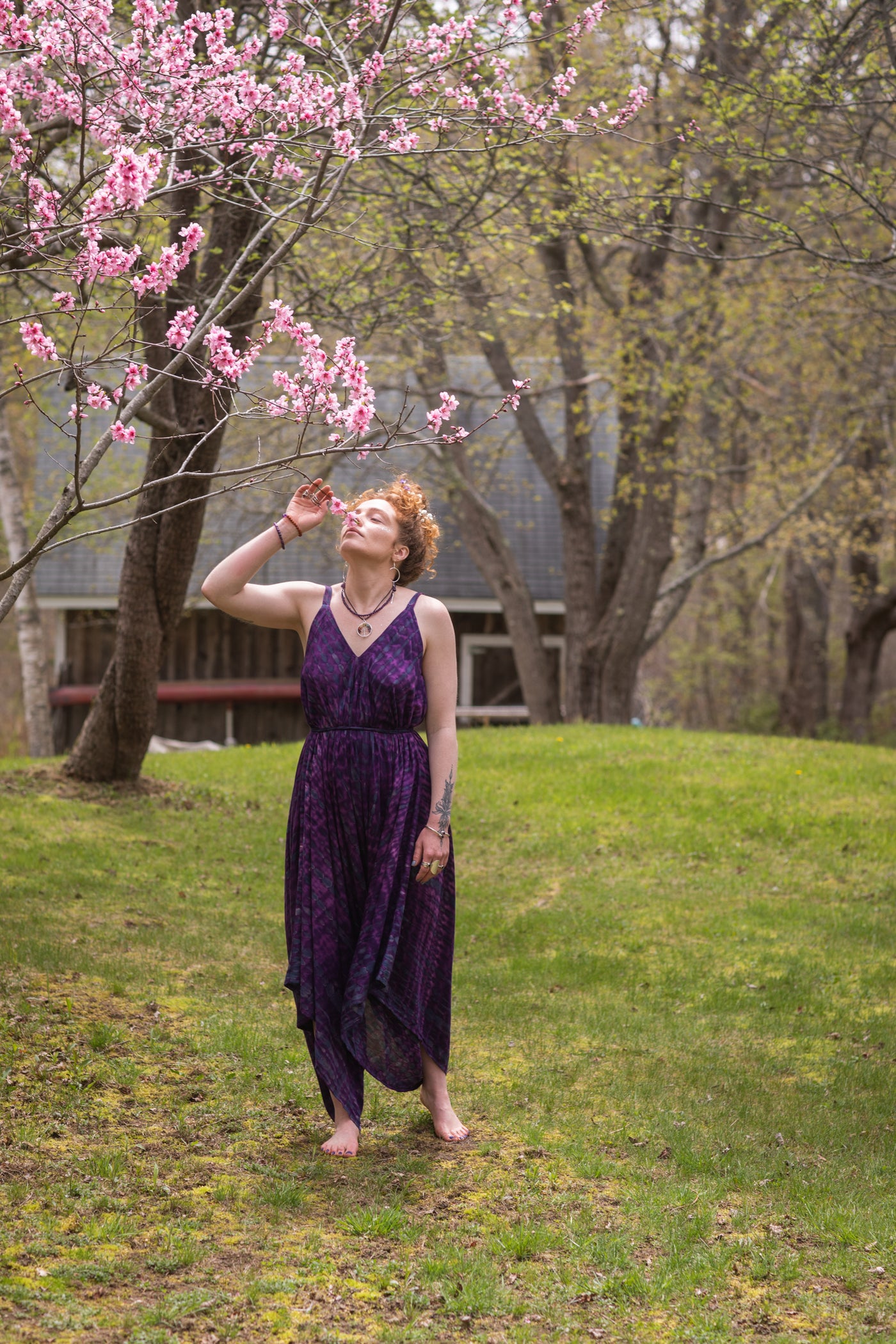 Carly is wearing a tie dye jumpsuit in purple