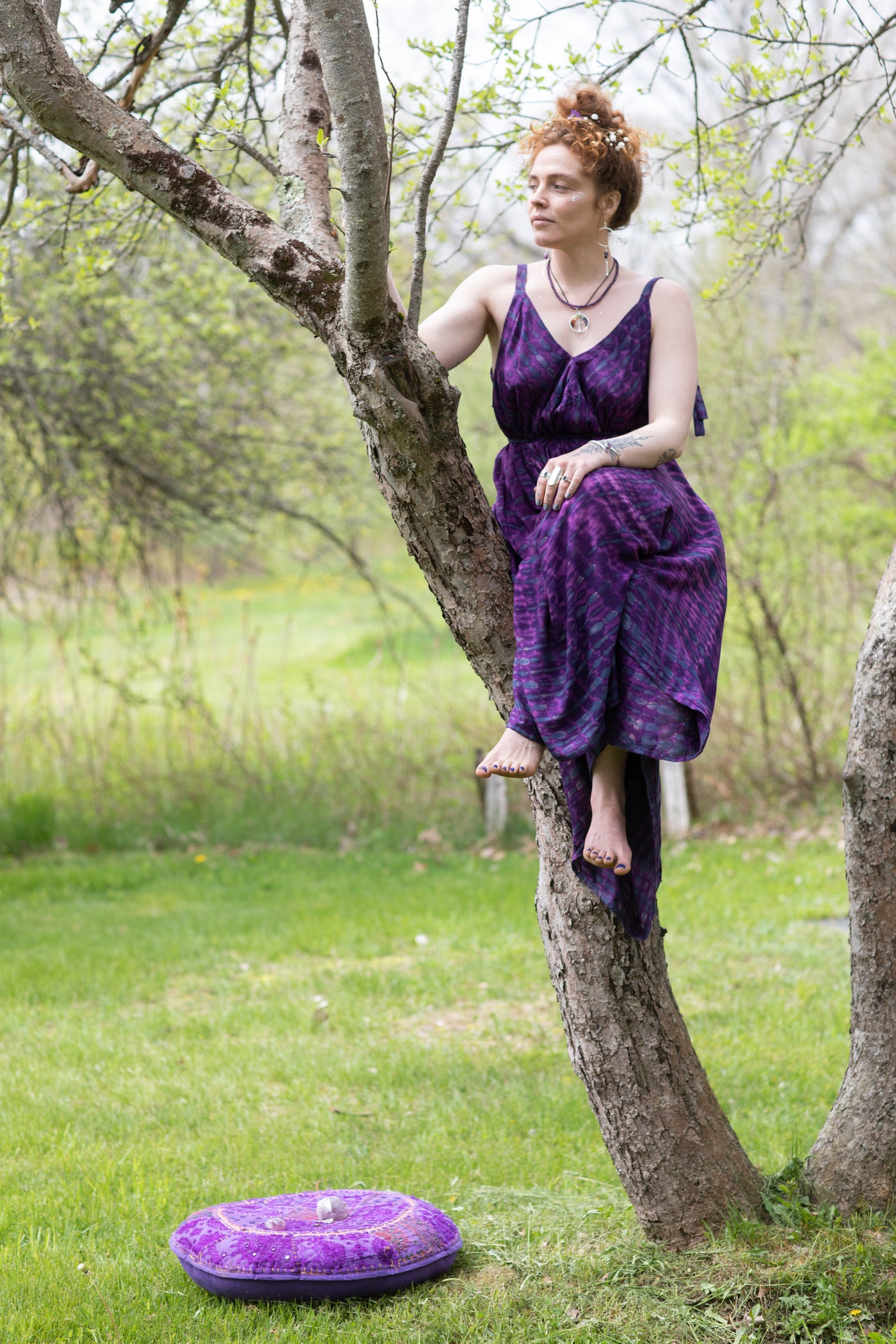 Carly is wearing a tie dye jumpsuit in purple
