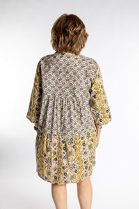 Betty is wearing the one size Shivani Tonal Cotton Tunic in Tan