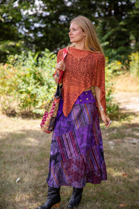 Sophie is carrying the  Recycled Kantha Patchwork Beach Bag and wearing the Jaya Patchwork Utility Skirt and the Asymmetrical Loose Weave Poncho. 