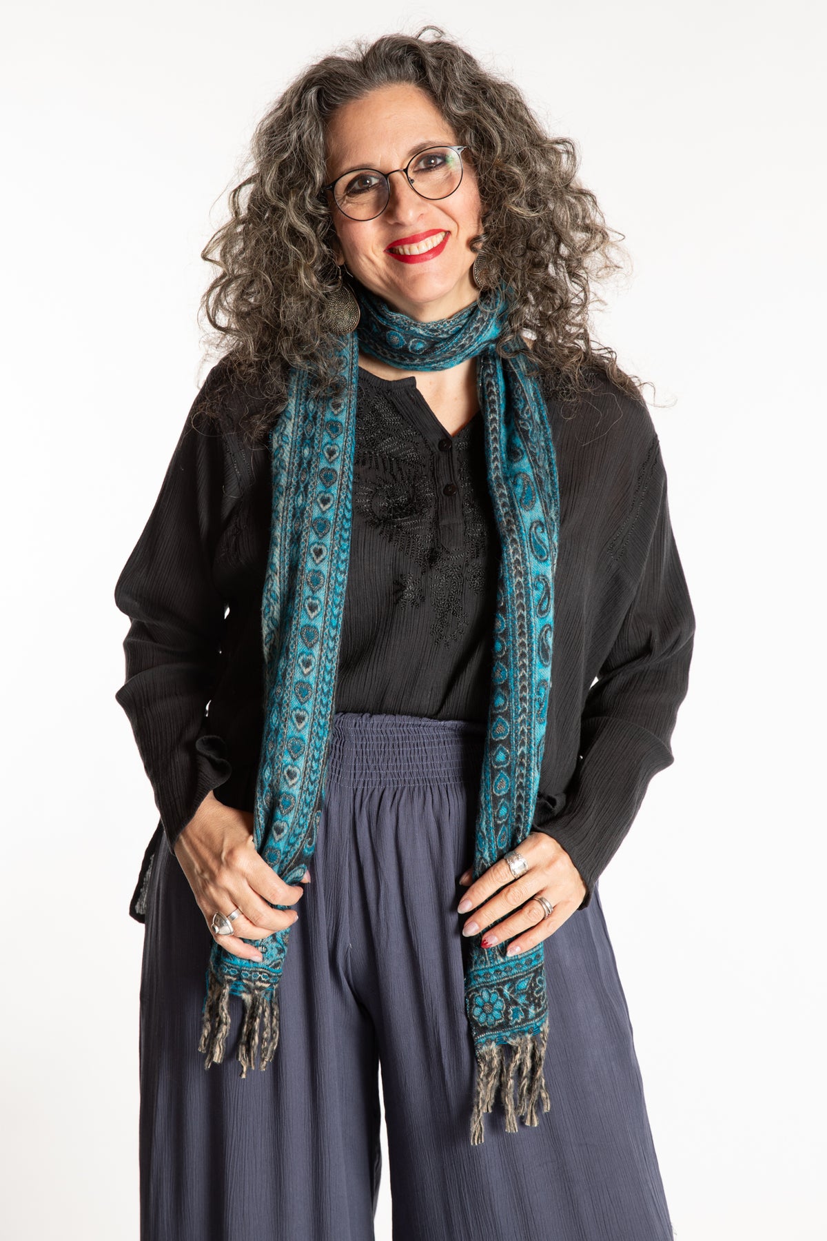 Susan is wearing the Striped Soft Brushed Scarf in Turquoise