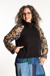 Susan is wearing the M/L Suhana Sari Patch Fleece Pullover in Black