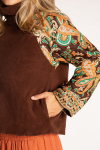 Sophie is wearing the S/M Suhana Sari Patch Fleece Pullover in Brown