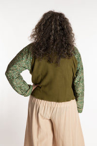 Susan is wearing the M/L Suhana Sari Patch Fleece Pullover in Green