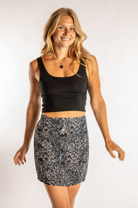 Sophie is wearing size S/M tank top in Black with batik skirt