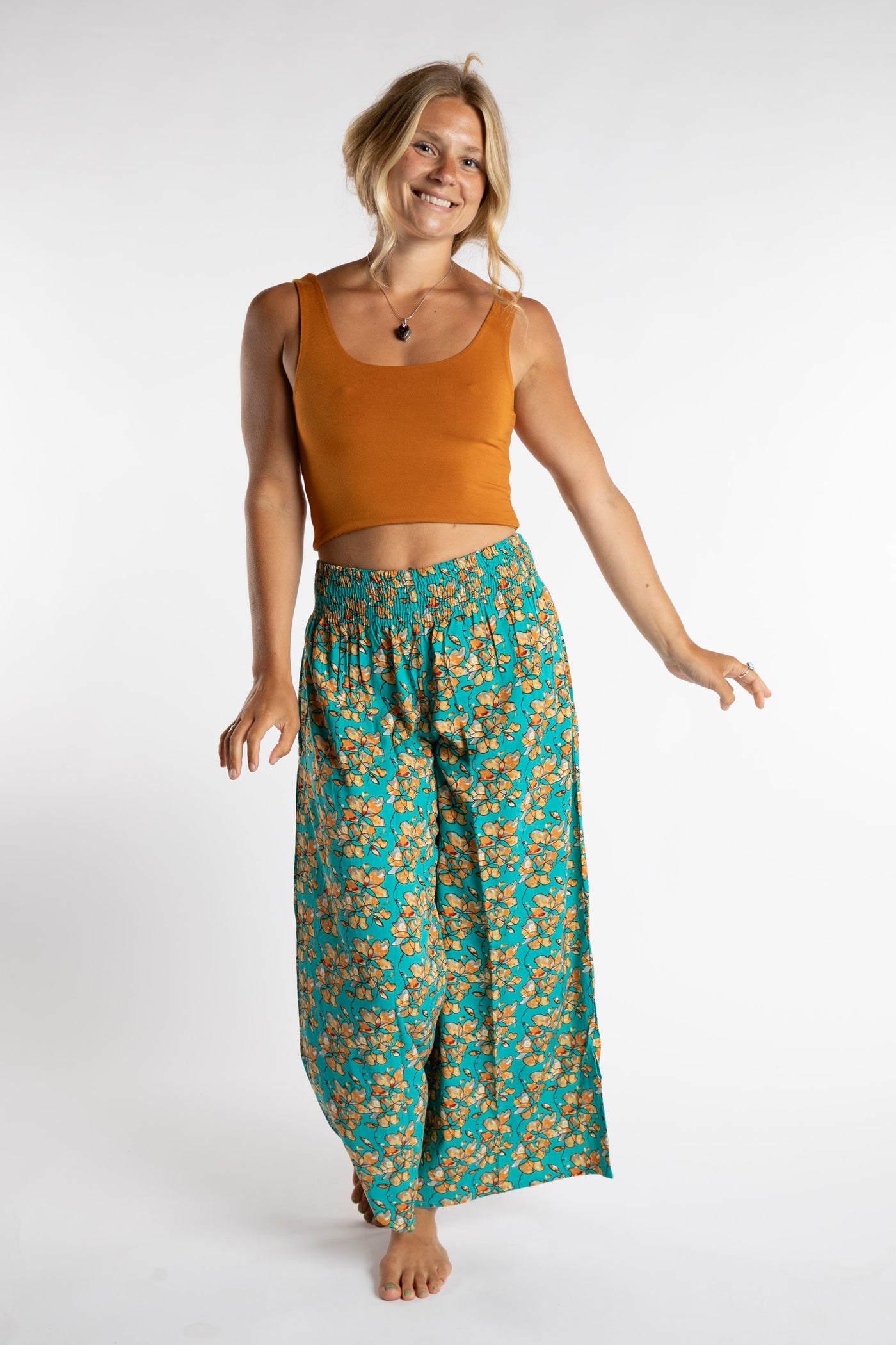 Sophie is wearing size S/M tank top in Yellow Mustard and floral printed penny lane pants