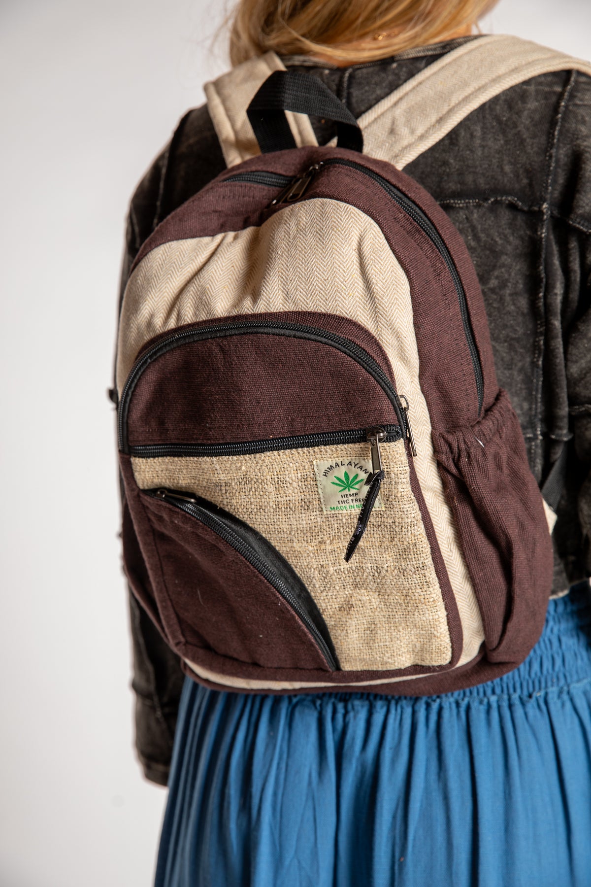 The Switchback Hemp Backpack in Brown being worn by Sophie. 