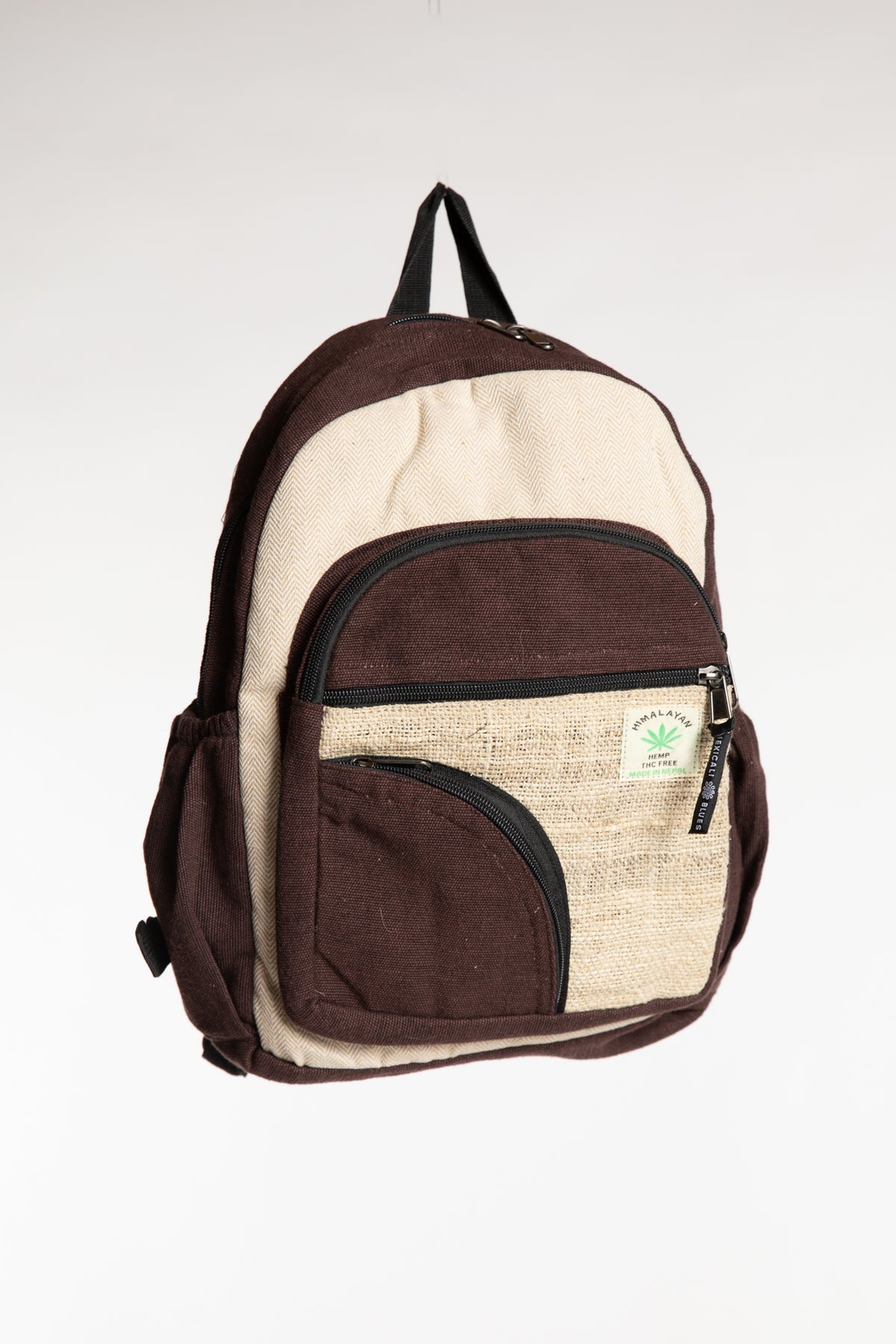 Brown hemp backpack with cream contrast panels and multiple zippered pockets