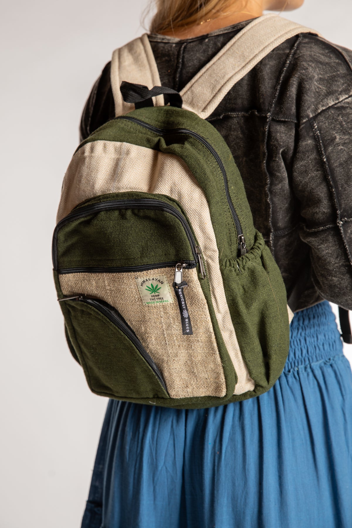 The Switchback Hemp Backpack in Green being worn by Sophie. 