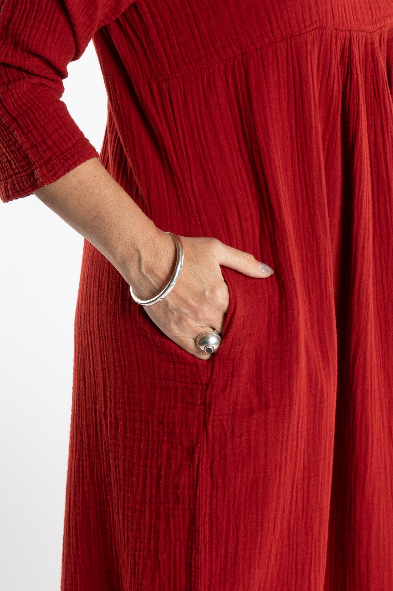 Susan is wearing the Tashi Cotton Day Dress in Paprika L/XL